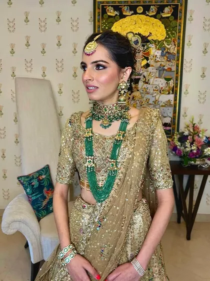 A three-quarter view of the regal bridal look, where the updo provides a perfect base for the maang tikka.