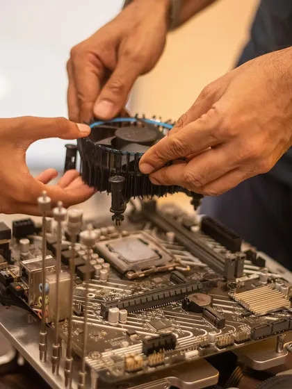 This is what real engagement looks like. We guide students as they handle complex components like motherboards and cooling fans, demystifying the technology inside a gaming PC and building their confidence with every part they install.