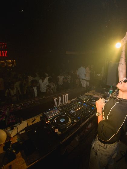 On the mic at Diaz, pointing to the sky. I'm always interacting with the crowd, making sure the energy never drops.