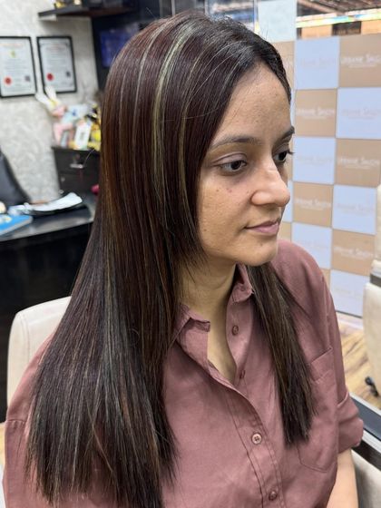 A beautiful result of our Botoliss treatment paired with cool Ash Blonde highlights. The hair is smooth, straight, and features beautifully blended, modern streaks.