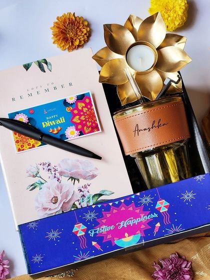 To break the monotony of typical Diwali gifts, I designed this modern hamper for the younger generation. It includes a personalized tumbler, a sleek black pen, and a floral-print notebook, combining festive happiness with everyday utility.