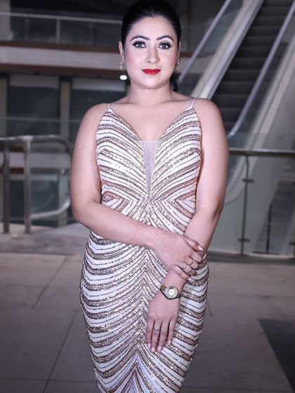 A classic pose in the rose gold sequin gown, showcasing its timeless glamour and modern design.