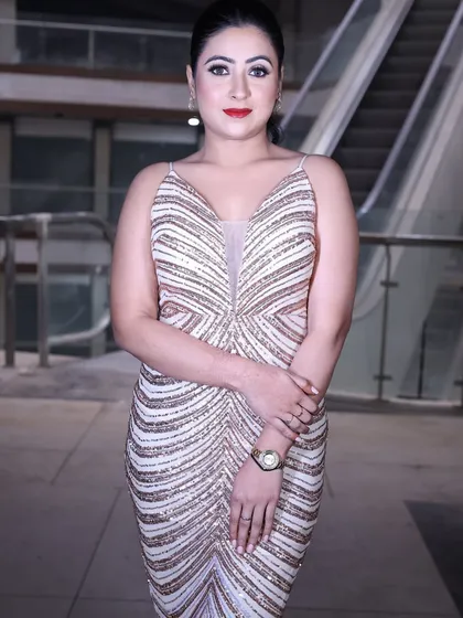 A classic pose in the rose gold sequin gown, showcasing its timeless glamour and modern design.