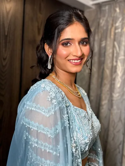 A three-quarter profile shot, showing how the makeup and hairstyle work together.