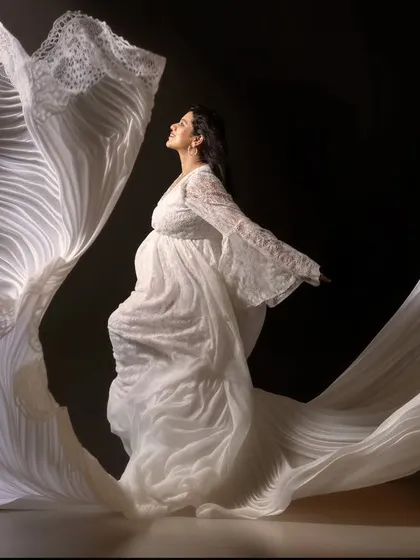 Grace in every fold, strength in every step. This portrait captures the quiet power of motherhood in motion, where the flowing white fabric seems to whisper a story of elegance and emotion.