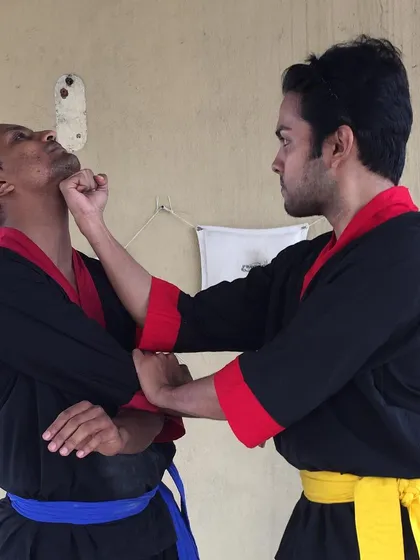 Wing Chun is a close-range fighting system. This image shows the application of a precise, straight-line punch to the chin, a core technique for effective self-defense.