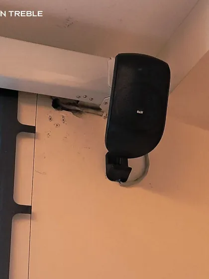 For this lounge theatre, we used compact Bowers & Wilkins speakers mounted on the wall. They deliver powerful surround sound without taking up floor space, perfect for a multi-use room.