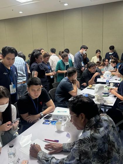 The training hall is buzzing with activity as doctors practice different aspects of hair transplantation.