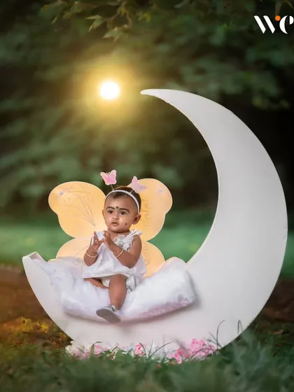 We create enchanting scenes for our fairy-themed shoots. Using props like this moon and soft lighting, we can turn a simple park into a whimsical wonderland for your child.
