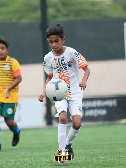 Perfect ball control. A young player juggles the ball, a drill that improves touch, balance, and confidence on the ball.