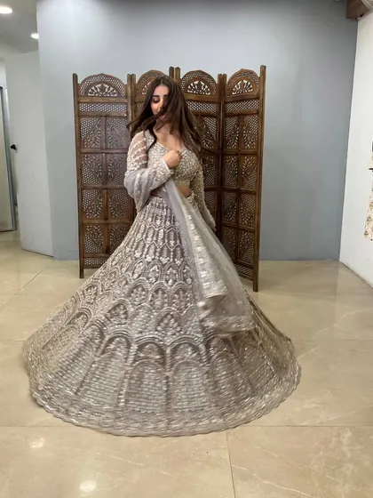 A dynamic shot capturing the movement and sparkle of this stunning grey lehenga.