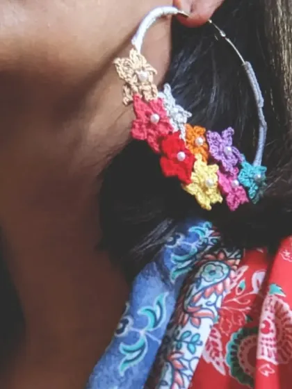 We love adding a pop of color with these floral crochet hoop earrings. They are incredibly lightweight and feature a cascade of multi-colored, handmade flowers, making them comfortable enough to wear all day.