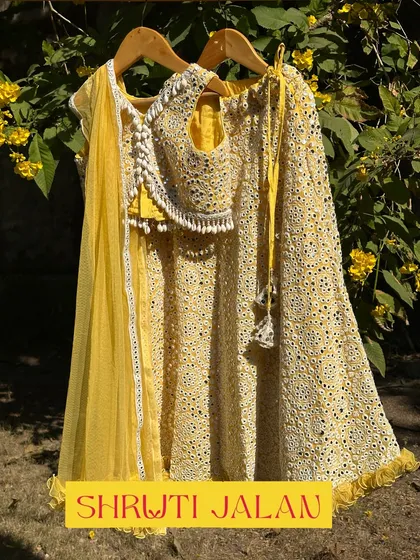 The yellow mirror-work lehenga in all its glory. The intricate work and the tassel tie on the skirt make it a true statement piece.