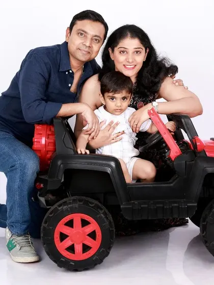 Family photoshoots should be fun, especially with little ones. We use playful props like this toy jeep to bring out genuine smiles and laughter, capturing the joyful, candid dynamic of your family in a relaxed studio setting.