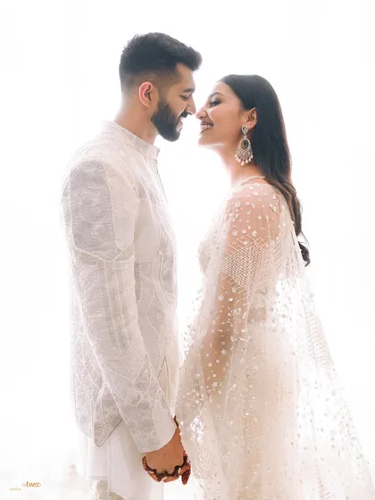 A bright, high-key portrait that feels fresh and full of love. Their happy expressions and the clean white background create a joyful and modern pre-wedding photo.