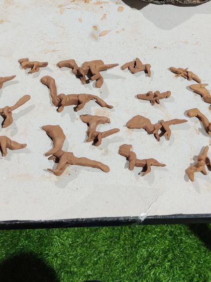 A whole herd of clay dinosaurs brought to life by a young enthusiast. Our kids' pottery sessions are a great way for children to express their passions.