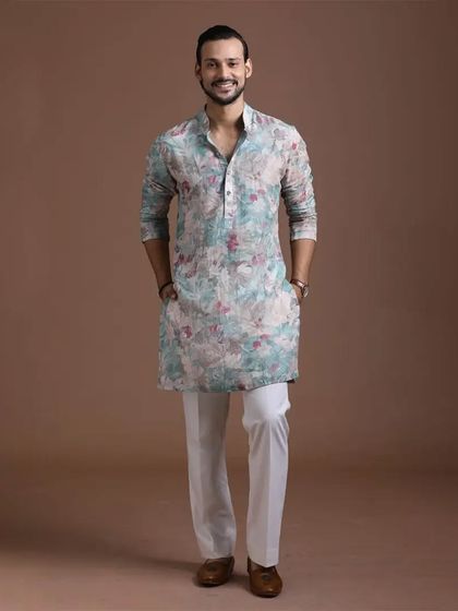 A floral printed kurta in a cool, refreshing palette. This piece is perfect for daytime events and festive gatherings, offering a contemporary take on traditional menswear.