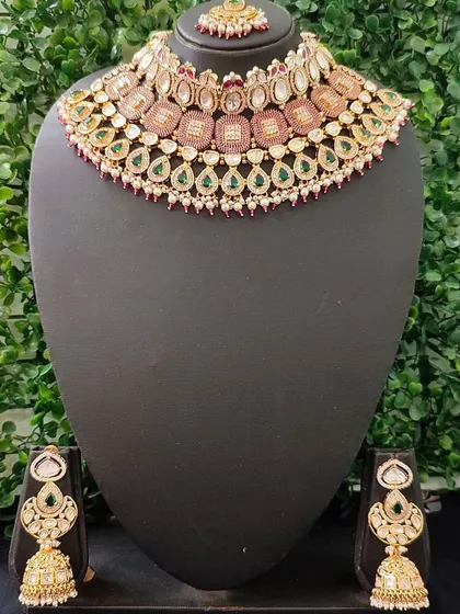A lovely pastel-toned kundan set with pink and green accents, perfect for a daytime wedding.