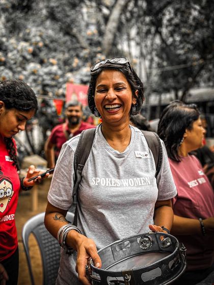 A happy moment captured during the drum circle. Our grey 'Spokes Women' tee is perfect for a relaxed and fun-filled day.