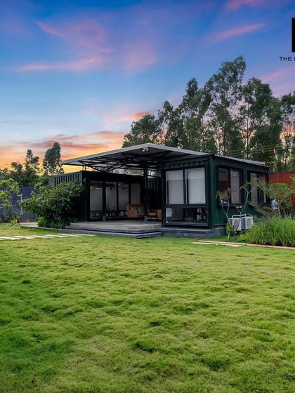 A stunning sunset view of one of our container office projects. The expansive green lawn and surrounding trees create a peaceful, park-like setting for a productive work environment.