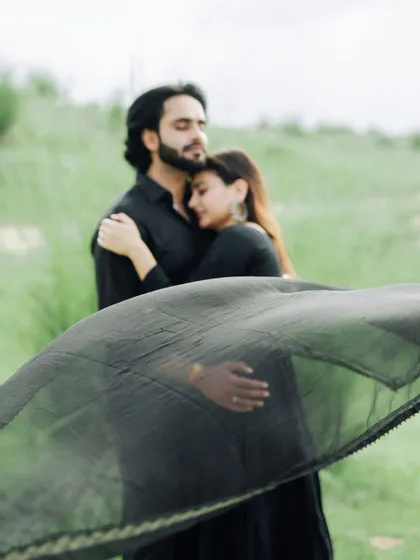 An artistic and emotional portrait, with a black dupatta flowing in the wind, adding a touch of mystery and grace.