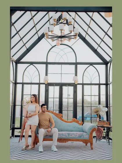 A stylish portrait in a beautiful glasshouse. The vintage chaise lounge and grand chandelier add a touch of elegance to this indoor pre-wedding shoot.
