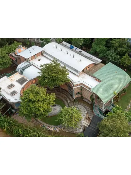 My designs work with the land, not against it. This aerial view of the Foothill Learning Centre shows how the building's flowing forms are nestled among existing trees, creating a campus that feels like a natural extension of the landscape.