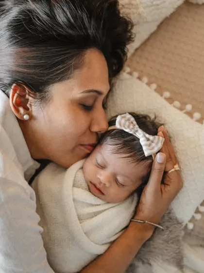 A mother's kiss is the sweetest thing. I aim to capture these simple, loving gestures during our lifestyle sessions, creating authentic and emotional portraits.