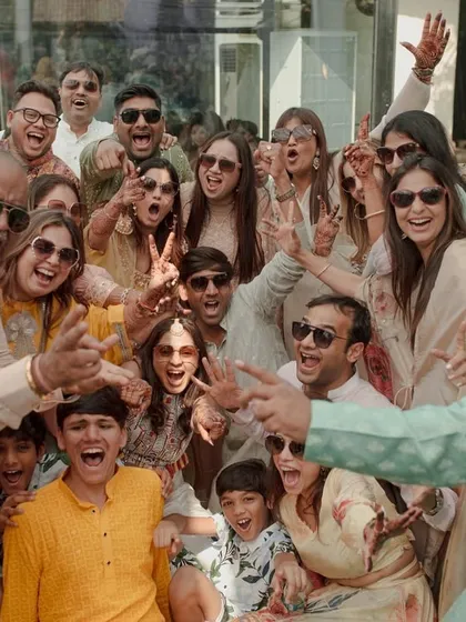 The entire family and all the friends in one high-energy group photo. This is what a big, happy Indian wedding celebration looks like.