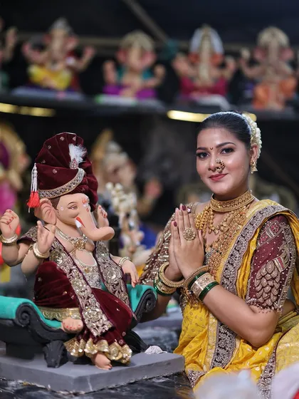 Welcoming Bappa in style. This yellow Nauvari saree paired with a maroon embroidered blouse and full temple jewellery is a popular choice for the Ganesh Chaturthi festival.