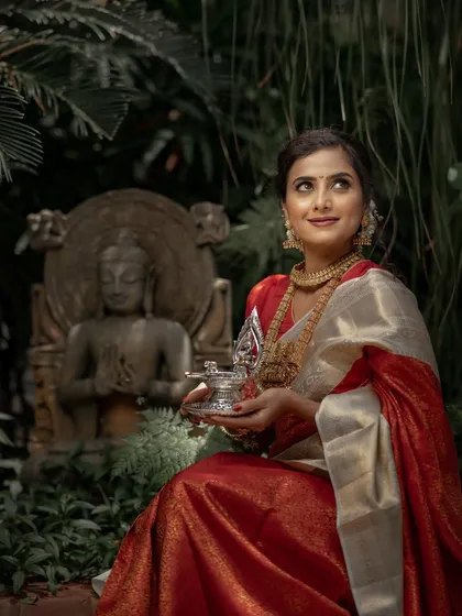 Looking towards the future with hope and joy. The classic red bridal saree is a perfect companion for a bride on her most important day.