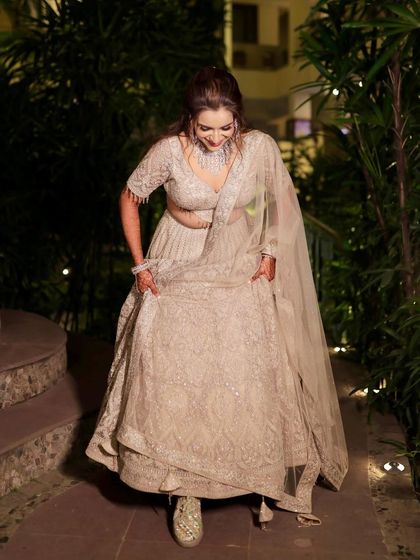 A fun, candid moment showing off the bride's comfortable yet stylish reception look, complete with sparkling sneakers.