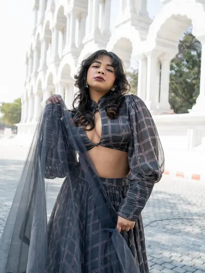 Who said Indian wear can't be playful? This fashion-forward grey plaid lehenga with bishop sleeves and a keyhole neckline is a fun and unique Indo-western look.