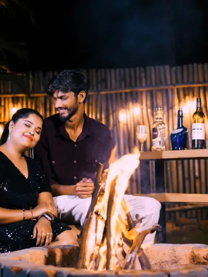 A cozy scene by the fire pit, with a beautifully arranged bar setup in the background. This shows how we create a complete, stylized experience.