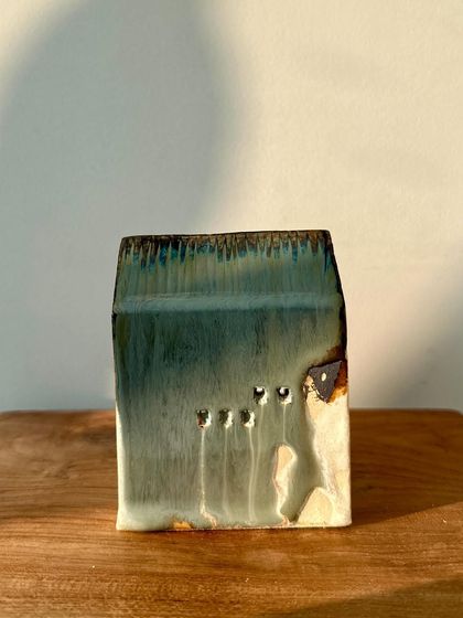 Another piece from our mini house series, with a subtle green glaze and small, carved windows that add character.