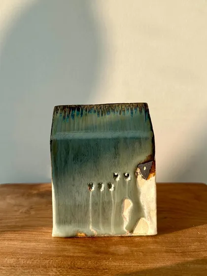 Another piece from our mini house series, with a subtle green glaze and small, carved windows that add character.