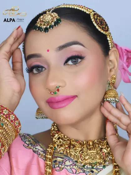 A close-up on the makeup, showing the soft pink eyeshadow, winged liner, and the unique nose pin that completes the look.