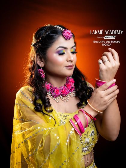 This Haldi look features beautiful floral jewelry and a bright yellow outfit. Our students learn to coordinate makeup colors with the client's attire and accessories for a cohesive look.