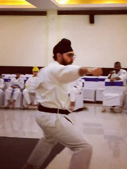 Senpai Harjas, a 1st Dan Black Belt, performs a powerful punch during a kata demonstration at our Kagami Biraki ceremony.