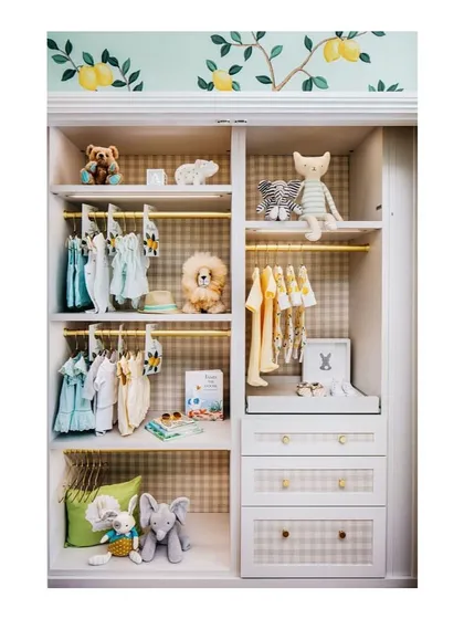 I believe the inside of a closet should be just as fun as the outside. For this baby's wardrobe, we used a cheerful gingham wallpaper and lemon-print accents to make it a happy little space.