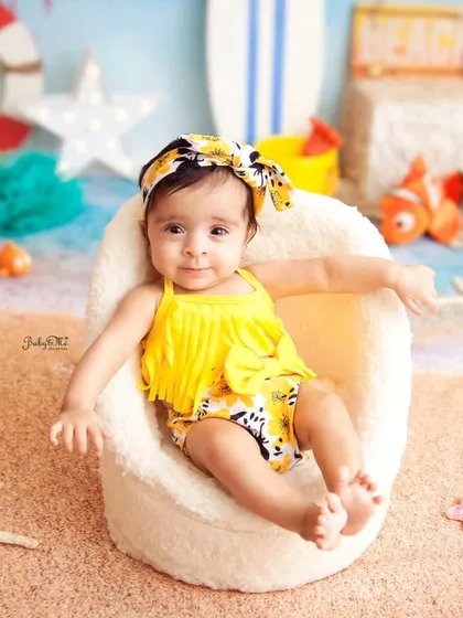 A relaxed pose from our little beach bum. The colorful and detailed beach setup in the studio makes you feel like you're right by the ocean.