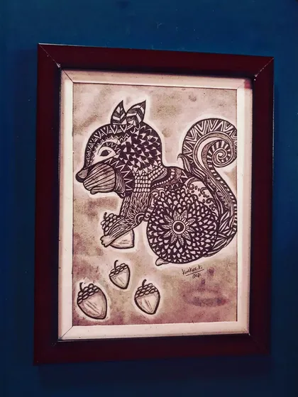 A playful squirrel, its body and tail decorated with various mandala and zentangle designs.