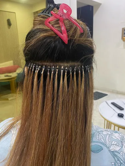 A close-up view of micro ring extensions during application. You can see the neat rows and how the individual strands create a very natural, integrated look.