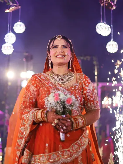 The bride's grand entrance is always a magical moment. I captured her radiant smile as she walked down the aisle, surrounded by sparklers and the joyful faces of her loved ones.