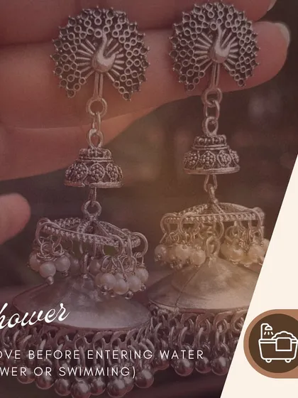 A quick tip for your jewellery. Always remove your earrings before showering or swimming to protect them from damage. This pair of silver peacock jhumkas deserves all the care.