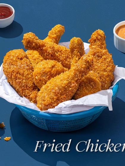 A basket of crispy fried chicken, a universally loved comfort food, shot for a Pepsi ad campaign.