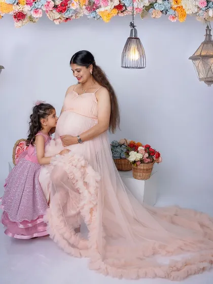 The bond between a mother and her child begins long before they meet. Here, a soon-to-be big sister shares a quiet, precious moment with her mother, whispering secrets to the baby on the way.