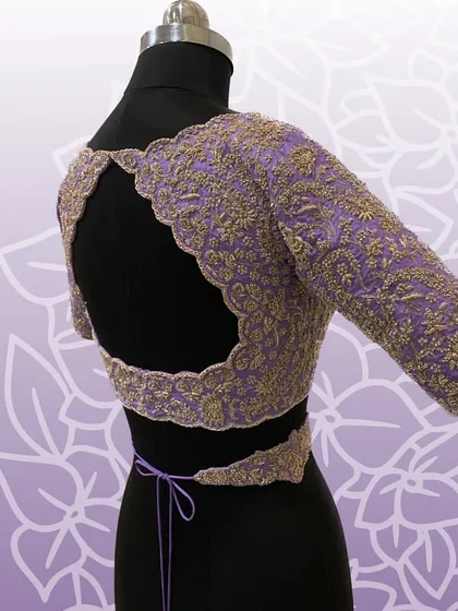This lavender bridal blouse features a stunning open-back design with scalloped, embroidered edges and a matching embroidered waistband.