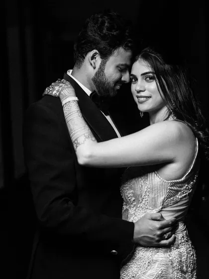 A timeless black and white embrace, where the focus is entirely on the couple's expression and the elegant lines of their formal wear.
