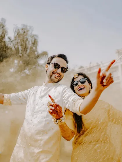 The Haldi ceremony is all about pure, unadulterated fun. I love capturing the playful energy, like this candid shot of a couple sharing a laugh, sunglasses on, fully embracing the joyful chaos of the moment. This is what I mean by capturing *masti bhare pal*.